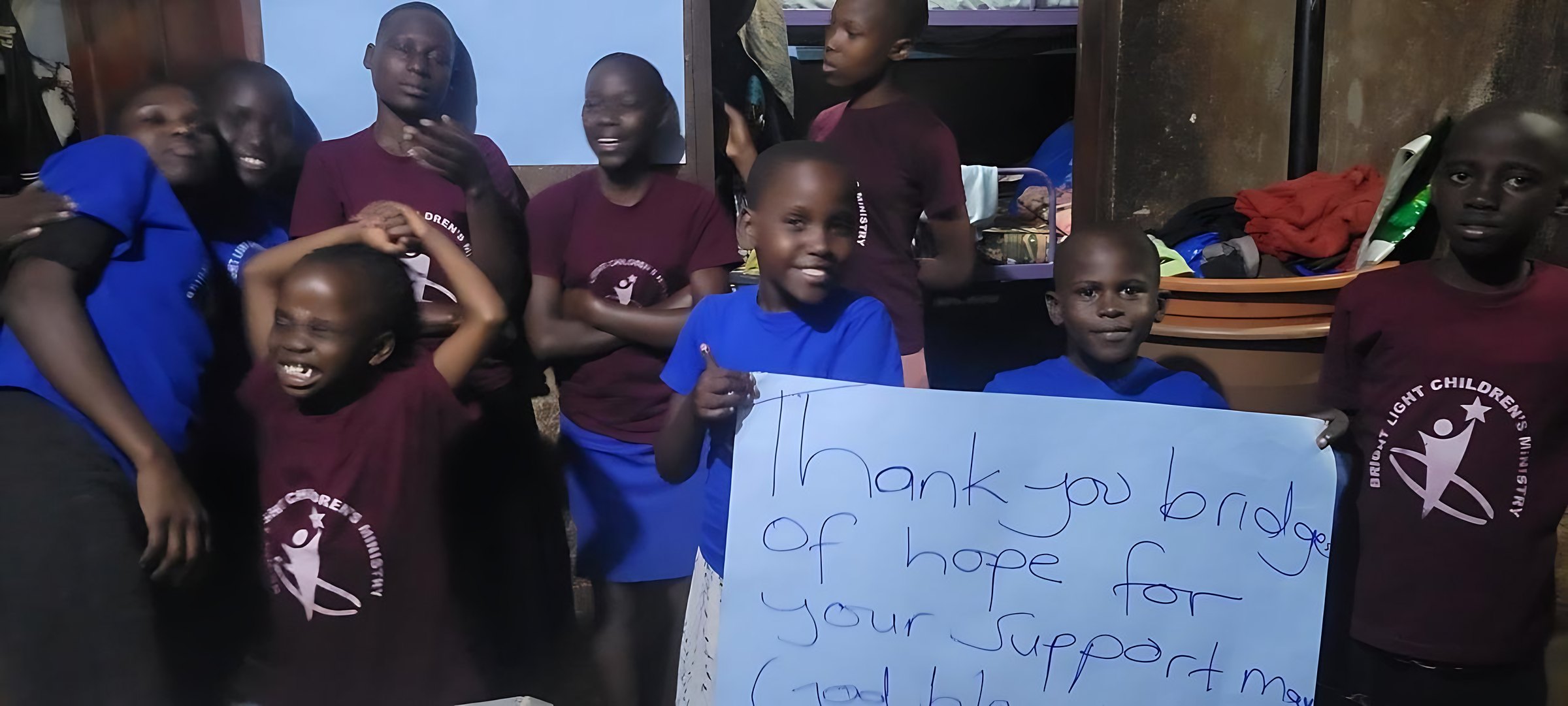 Children in Uganda holding a thank-you sign